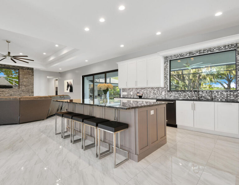 Remodeled kitchen with custom white kitchen cabinets and custom gray island